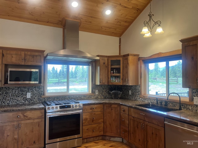 kitchen featuring appliances with stainless steel finishes, wall chimney exhaust hood, sink, a notable chandelier, and wooden ceiling