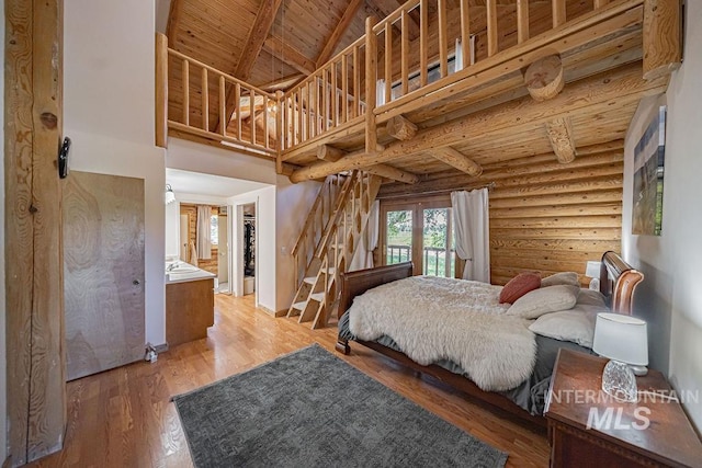 bedroom featuring wooden ceiling, wood finished floors, log walls, high vaulted ceiling, and beam ceiling