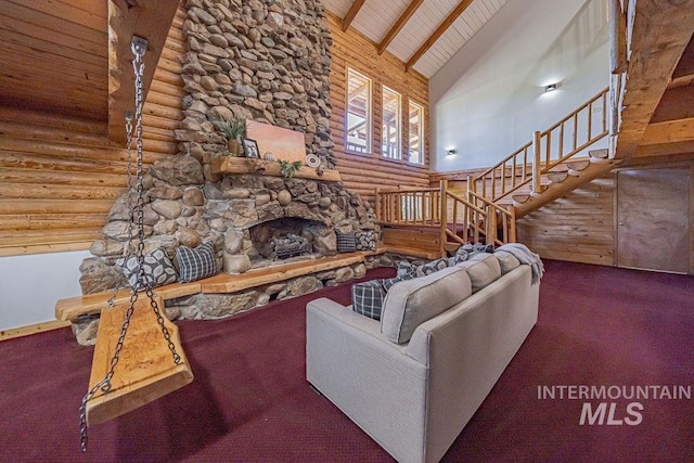 carpeted living area featuring high vaulted ceiling, a fireplace, wood ceiling, stairs, and beamed ceiling