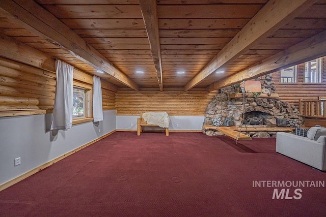 unfurnished room with a fireplace, carpet flooring, wood ceiling, baseboards, and beam ceiling