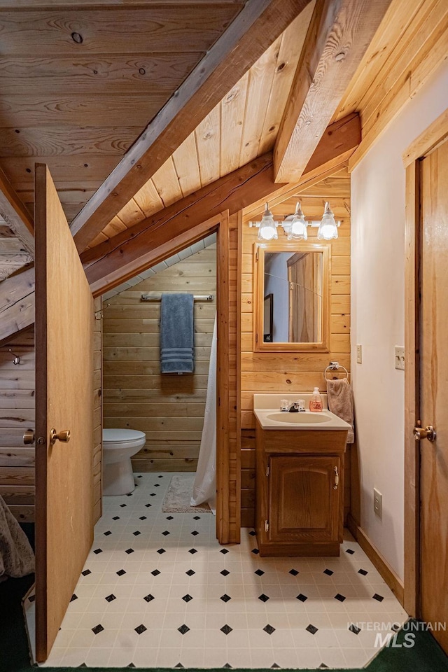 bathroom featuring lofted ceiling with beams, wood walls, vanity, and wood ceiling