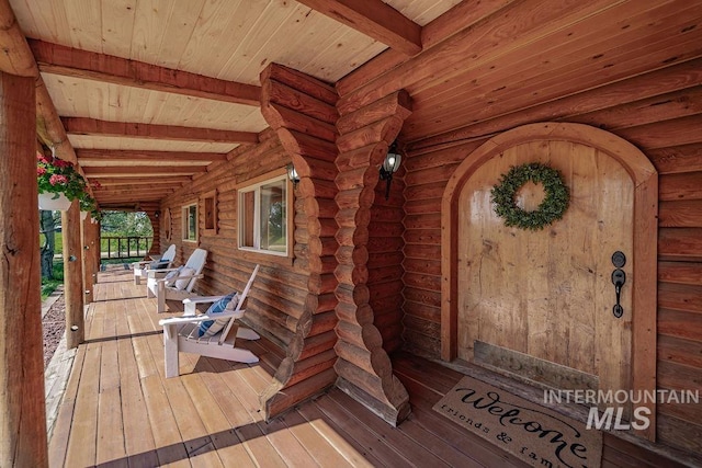 wooden terrace with a porch