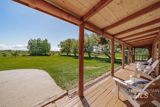 deck featuring a yard and a patio area