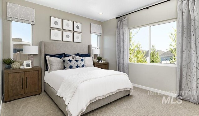 carpeted bedroom featuring baseboards