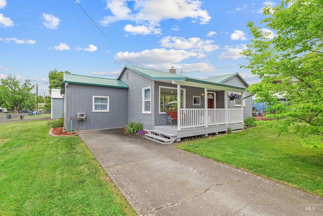 3233 8th St, Lewiston, ID 83501 - ranch-style house featuring covered porch, a front yard, metal roof, and driveway