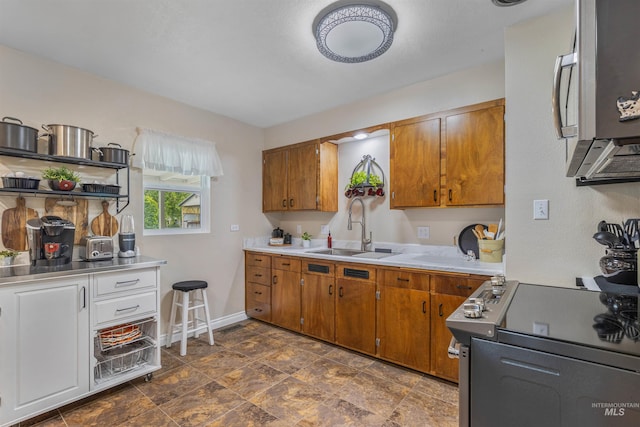 3233 8th St, Lewiston, ID 83501 - kitchen with a sink, stainless steel appliances, light countertops, and brown cabinetry