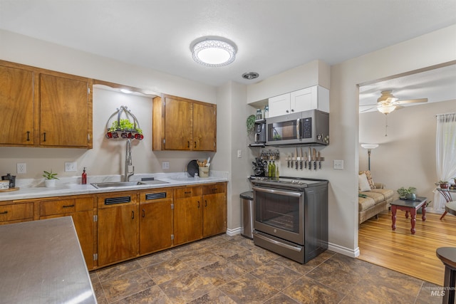 3233 8th St, Lewiston, ID 83501 - kitchen featuring stainless steel appliances, brown cabinets, and light countertops