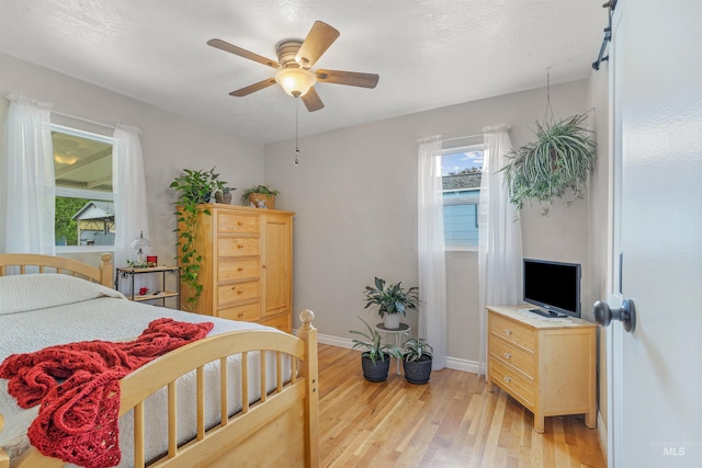 3233 8th St, Lewiston, ID 83501 - bedroom featuring light wood-style flooring, multiple windows, baseboards, and a ceiling fan