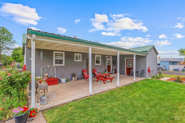3233 8th St, Lewiston, ID 83501 - back of house featuring a lawn, metal roof, and a patio