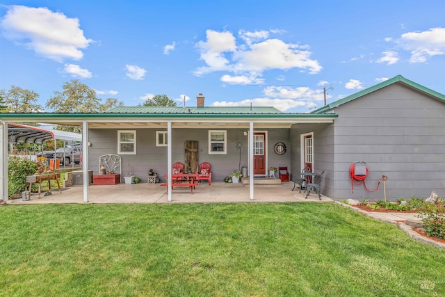 3233 8th St, Lewiston, ID 83501 - back of property featuring a lawn, a chimney, a patio, metal roof, and central AC
