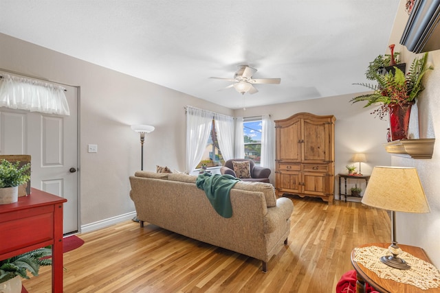 3233 8th St, Lewiston, ID 83501 - living room featuring a ceiling fan, light wood-style floors, and baseboards