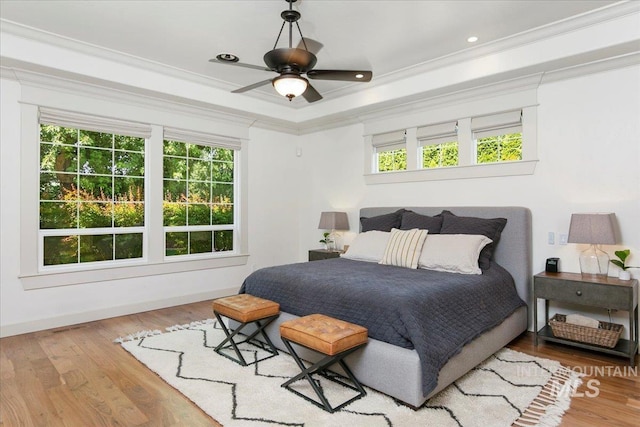 bedroom with ceiling fan, ornamental molding, and hardwood / wood-style floors