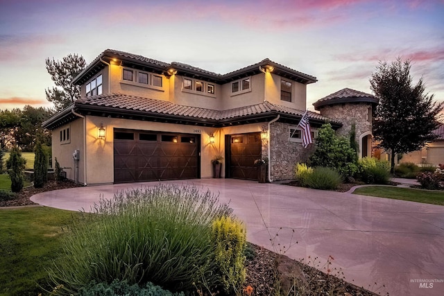 mediterranean / spanish-style home with a garage