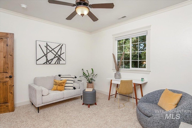 sitting room with ornamental molding, light colored carpet, and ceiling fan