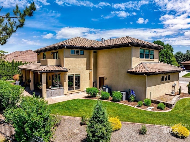 back of house featuring a yard and a patio