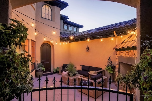 patio terrace at dusk featuring outdoor lounge area