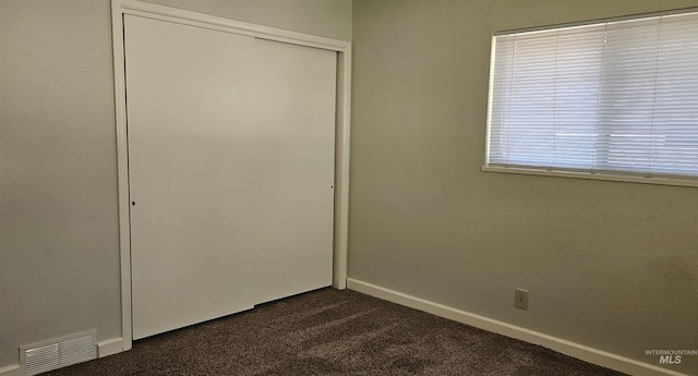 604 Monte Vis, Twin Falls, ID 83301 - unfurnished bedroom featuring dark colored carpet and a closet