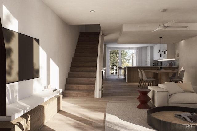 living room featuring light wood-type flooring, stairway, a ceiling fan, and recessed lighting