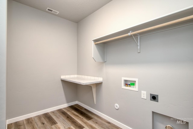 3542 W Littleton Dr, Meridian, ID 83642 - laundry room with electric dryer hookup, hookup for a washing machine, wood finished floors, and baseboards
