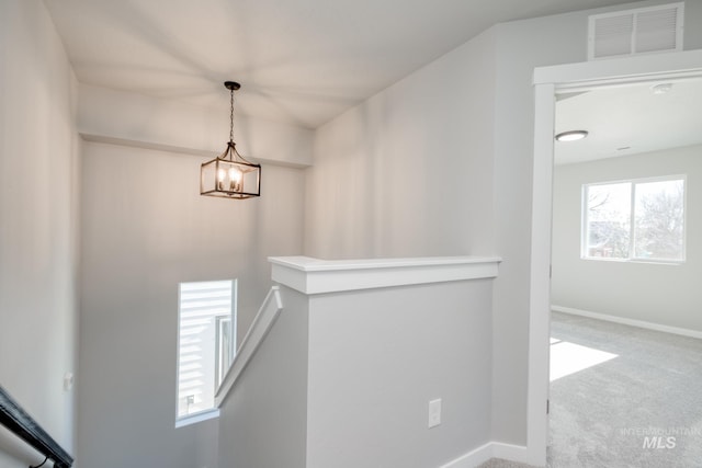 3542 W Littleton Dr, Meridian, ID 83642 - hall with an upstairs landing, carpet flooring, baseboards, and a chandelier