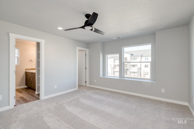 3542 W Littleton Dr, Meridian, ID 83642 - unfurnished bedroom featuring light carpet, baseboards, ensuite bathroom, recessed lighting, and a ceiling fan