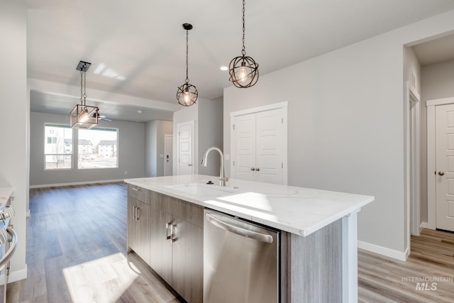 3542 W Littleton Dr, Meridian, ID 83642 - kitchen featuring dishwasher, a sink, baseboards, and light wood-type flooring