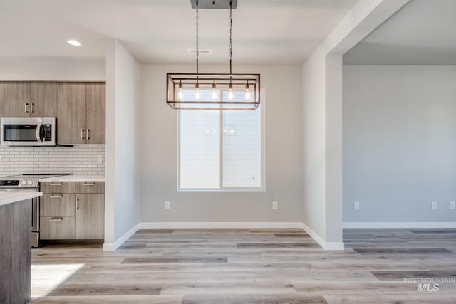 3542 W Littleton Dr, Meridian, ID 83642 - kitchen with stainless steel appliances, light countertops, decorative backsplash, recessed lighting, and light wood-type flooring