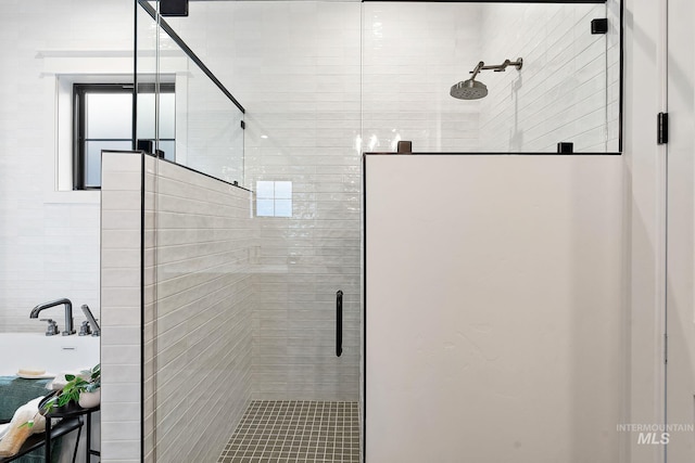 bathroom with a shower with door