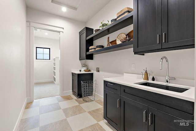 interior space featuring sink, hookup for a washing machine, and cabinets