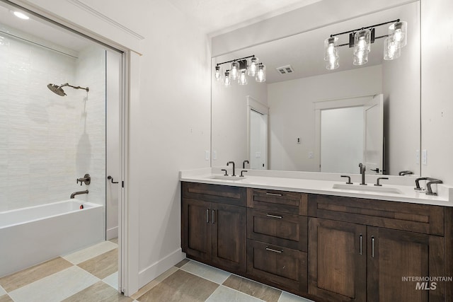 bathroom featuring tiled shower / bath and vanity