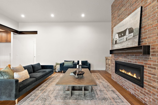 living room with hardwood / wood-style flooring and a fireplace