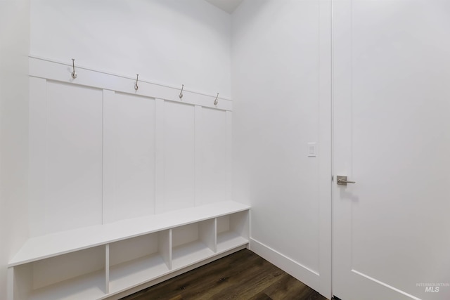 mudroom featuring dark wood finished floors and baseboards