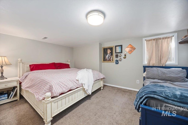 carpeted bedroom featuring visible vents and baseboards