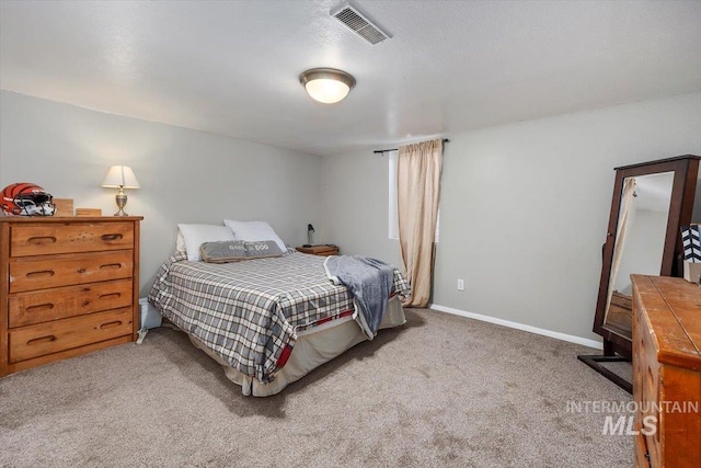 bedroom with visible vents, carpet floors, and baseboards