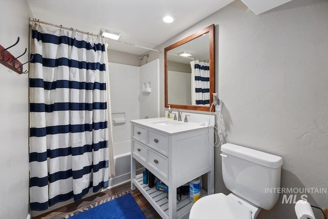 full bathroom with visible vents, toilet, shower / bath combo, wood finished floors, and vanity