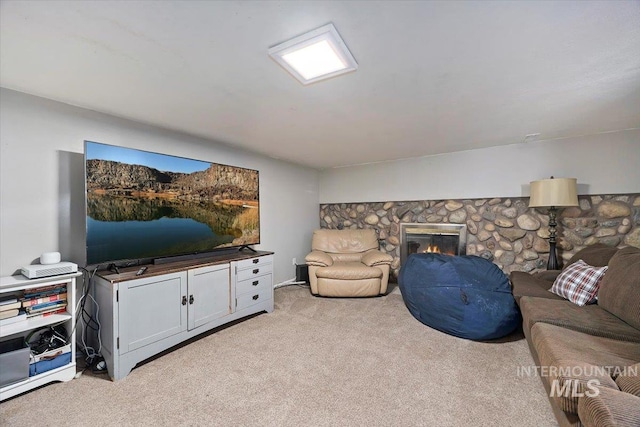 living room with light colored carpet and a fireplace