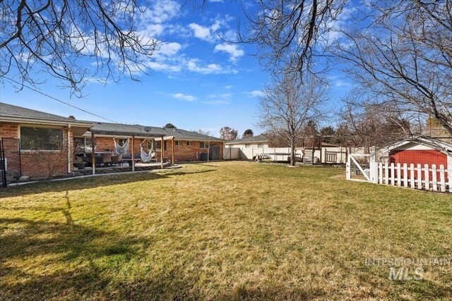 view of yard featuring a patio area and a fenced backyard