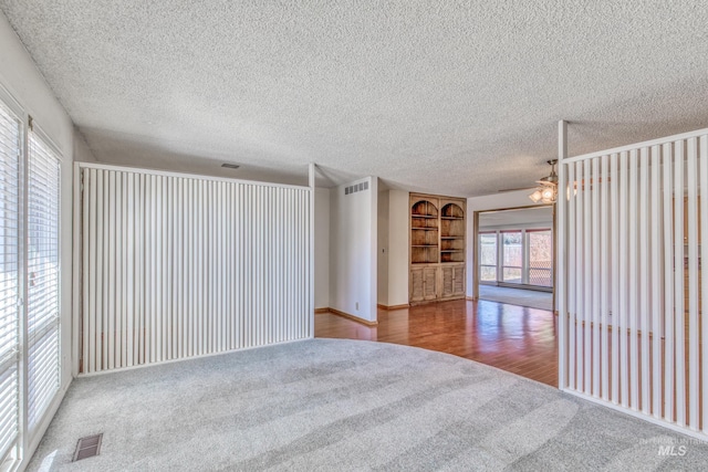 412 N Purdue St, Boise, ID 83706 - carpeted spare room featuring a textured ceiling, ceiling fan, wood finished floors, and baseboards