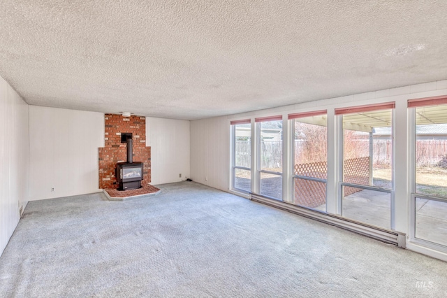 412 N Purdue St, Boise, ID 83706 - unfurnished living room featuring healthy amount of natural light, carpet flooring, a wood stove, a textured ceiling, and a baseboard heating unit