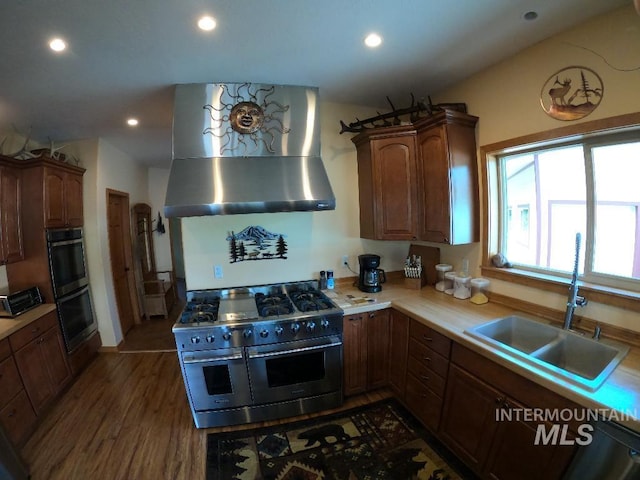 204 S 2nd St, Elk River, ID 83827 - kitchen featuring stainless steel appliances, wall chimney range hood, light countertops, recessed lighting, and dark wood finished floors