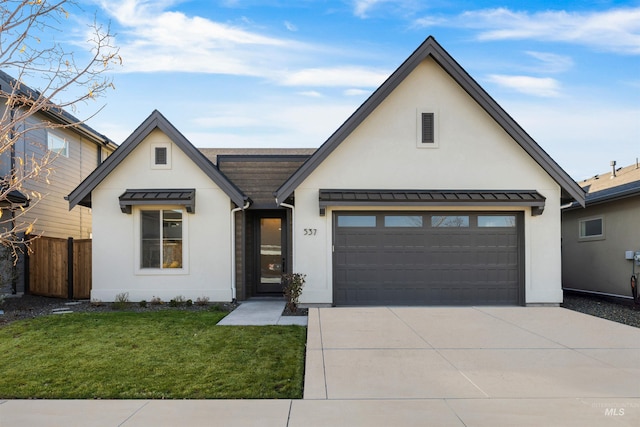 modern farmhouse featuring a front yard and a garage