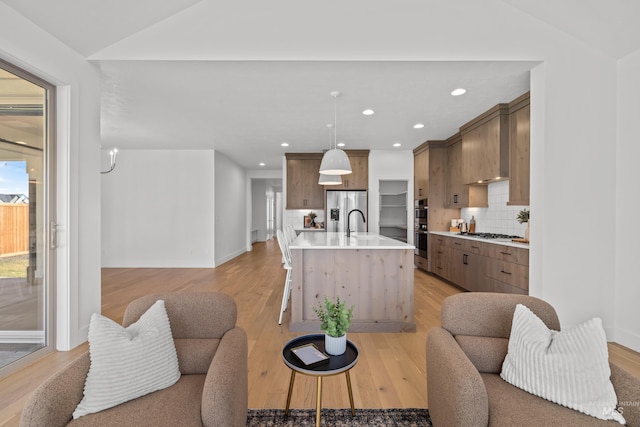 living room featuring light hardwood / wood-style flooring and vaulted ceiling