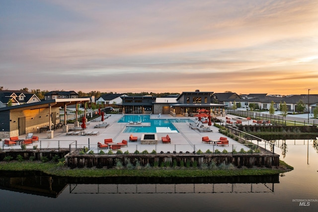 pool at dusk with a water view