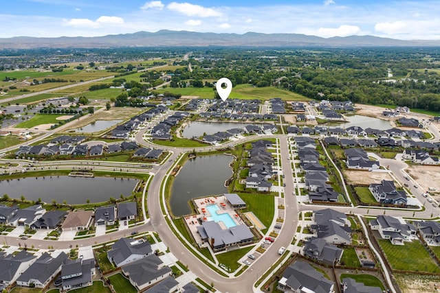 drone / aerial view with a water and mountain view