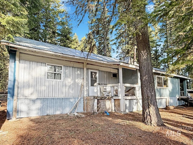 view of property exterior with metal roof