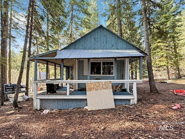 rear view of property featuring board and batten siding