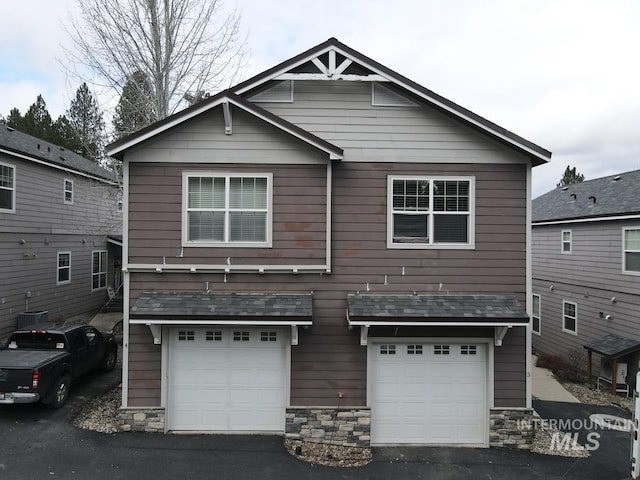 view of front of house with central AC unit and a garage