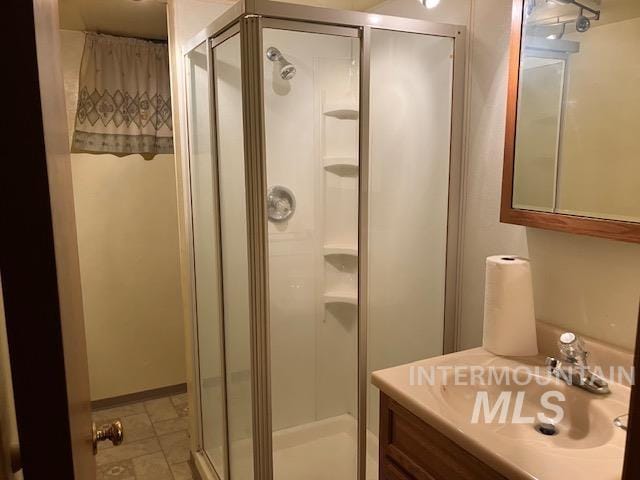 bathroom featuring vanity and a shower with door