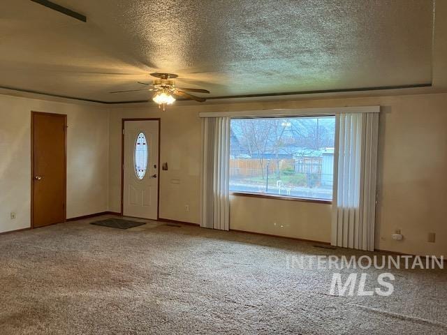 entryway with carpet, a textured ceiling, and ceiling fan