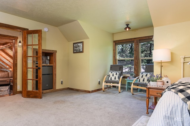 bedroom with lofted ceiling, carpet floors, a textured ceiling, and baseboards